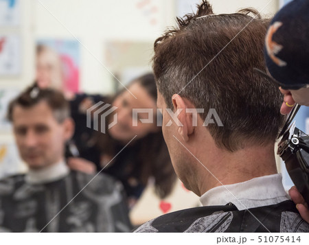 Barber trim man client with clipper machine 51075414