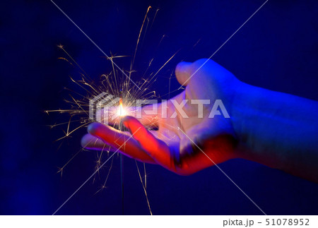 Hand Holding Fire Light Sparkler 51078952