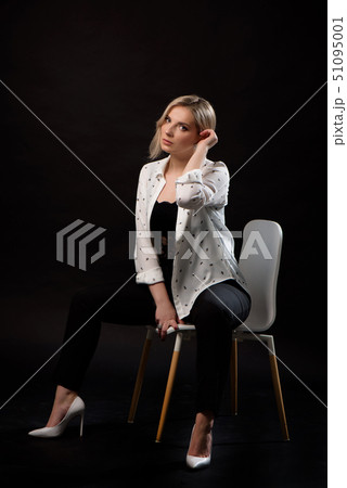 Young business woman posing isolated over black 51095001