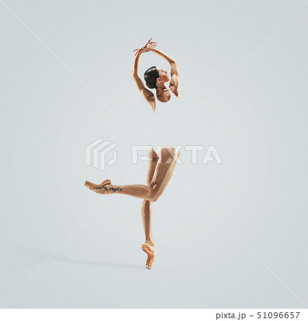 Ballerina. Young graceful female ballet dancer dancing over grey studio. Beauty of classic ballet. Ballerina. Young graceful female ballet dancer dancing over grey studio. Beauty of classic ballet. 51096657