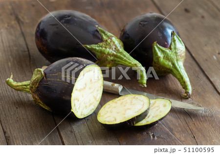 Fresh Raw eggplants with knife Fresh Raw eggplants with knife 51100595