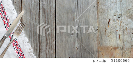 Vintage fork and knife on napkin on old wood 51100666