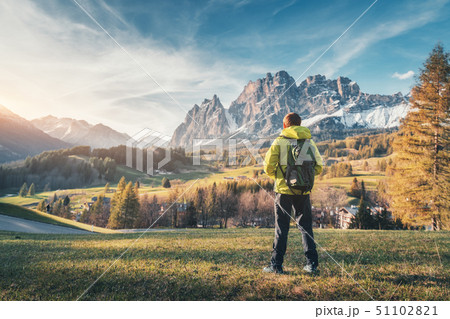 Young man in yellow jacket with backpack  51102821