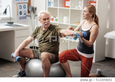 Pleasant professional female trainer being with a patient Pleasant professional female trainer being with a patient 51105601