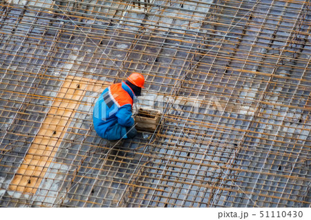 People work with reinforcement carcass made of fitness at construction site People work with reinforcement carcass made of fitness at construction site 51110430