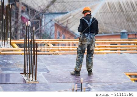 Back view construction site worker in helmet Back view construction site worker in helmet 51111560