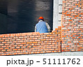 View of mason laying bricks at construction site 51111762