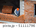 View of mason laying bricks at construction site 51111796