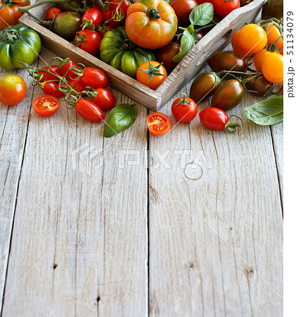 Colorful tomatoes on a wooden table Colorful tomatoes on a wooden table 51134079