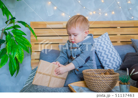 Baby boy playing with gift box Baby boy playing with gift box 51137463