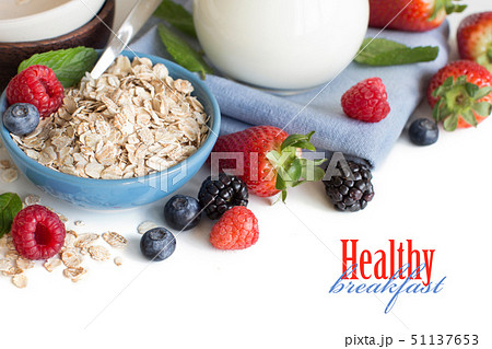 Rolled oats in a bowl with berries and milk Rolled oats in a bowl with berries and milk 51137653