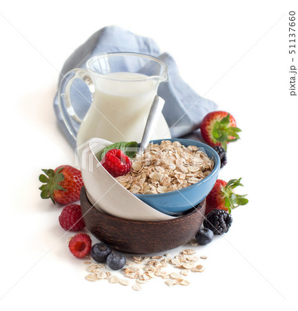 Rolled oats in a bowl with berries and milk Rolled oats in a bowl with berries and milk 51137660