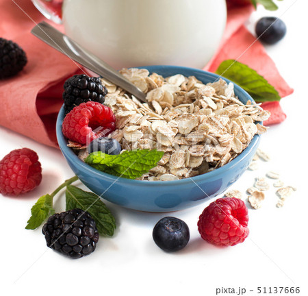 Rolled oats in a bowl with berries and milk 51137666