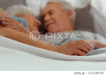 Close-up photo of spouses lying in the bed and hugging 51138479