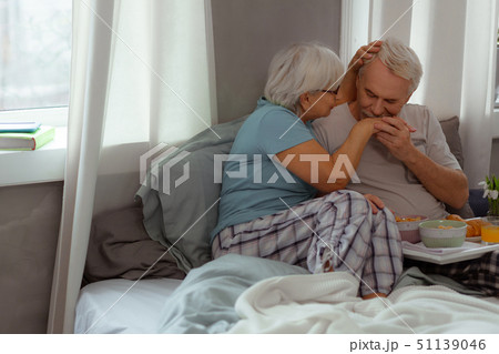 Good-looking spouse kissing the hand of his wife Good-looking spouse kissing the hand of his wife 51139046