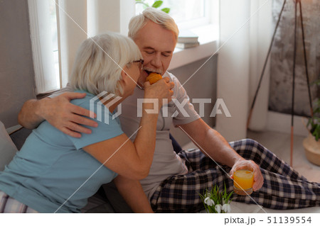 Nice-looking lady feeding up her husband with a freshly-baked croissant 51139554