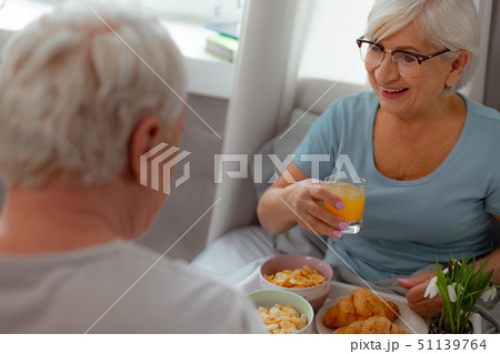 Happy woman enjoying breakfast in the bed with her spouse Happy woman enjoying breakfast in the bed with her spouse 51139764