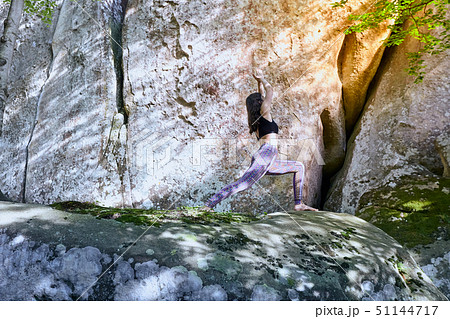 Young girl in mountains doing yoga exercise outdoor. Young girl in mountains doing yoga exercise outdoor. 51144717