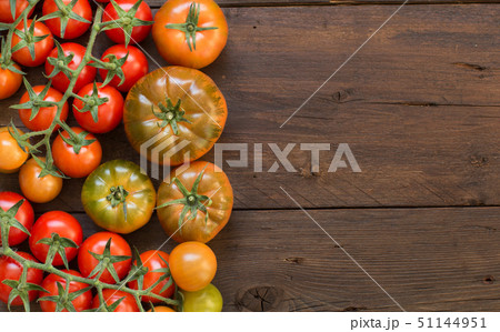 Fresh tomatoes on a wooden background 51144951