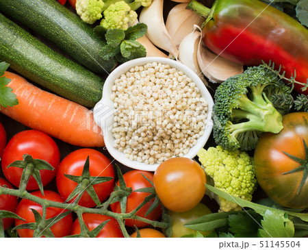 White sorghum grain in a bowl with vegetables 51145504