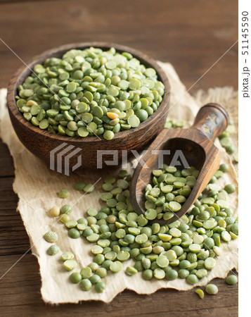 Uncooked Green Split Peas in a bowl  with a spoon 51145590