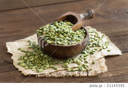 Uncooked Green Split Peas in a bowl with a spoon Uncooked Green Split Peas in a bowl with a spoon 51145595