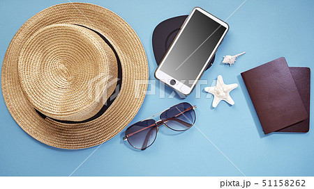 hat smartphone and sunglasses blue background 51158262