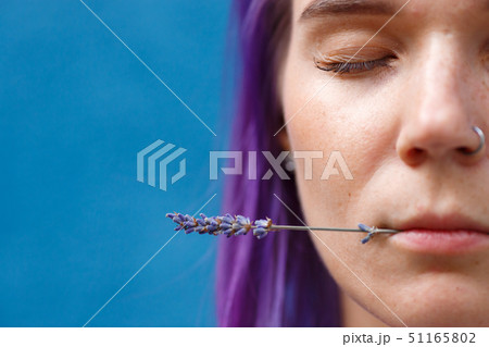 girl with purple hair holds lips lavender flower 51165802