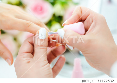 Experienced nail technician applying nail color 51172532