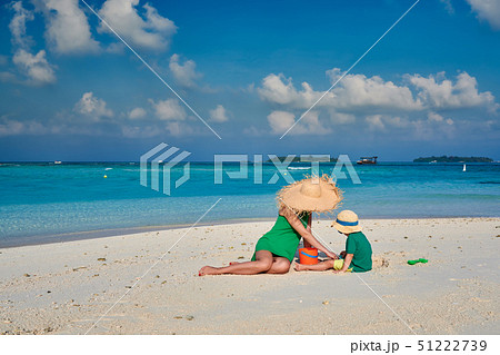Woman in green dress with three year old boy on Woman in green dress with three year old boy on 51222739