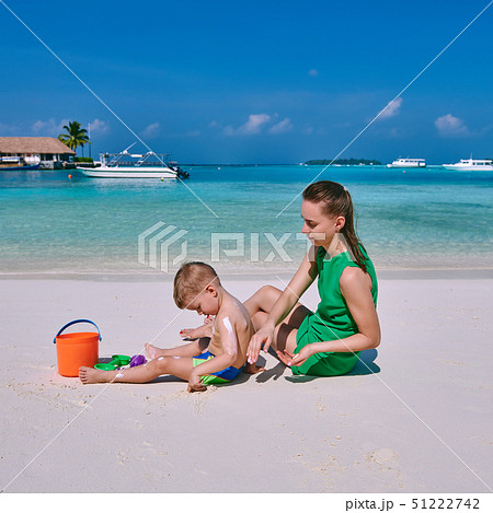 Woman applying sun screen on boy's back 51222742