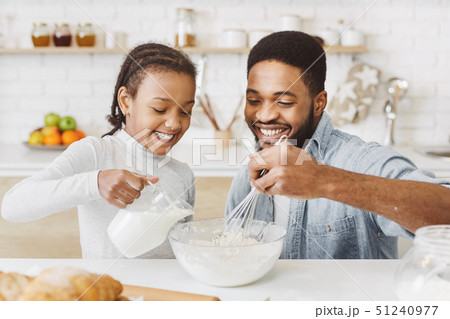 Father and daughter cooking together Father and daughter cooking together 51240977