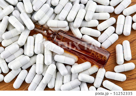 Many white pills and brown ampoule Many white pills and brown ampoule 51252335