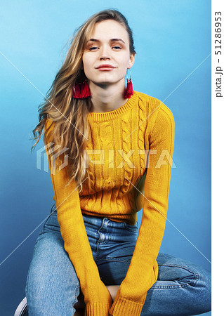 young pretty teenage modern hipster girl posing emotional happy on blue background, lifestyle people 51286953