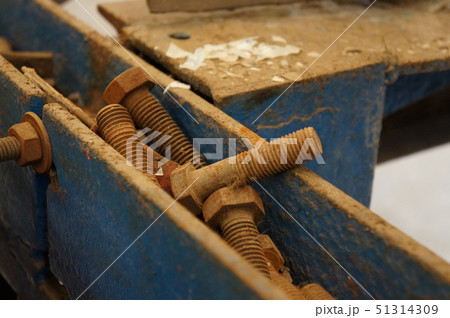 Old rusty Screw heads metal on blue box 51314309