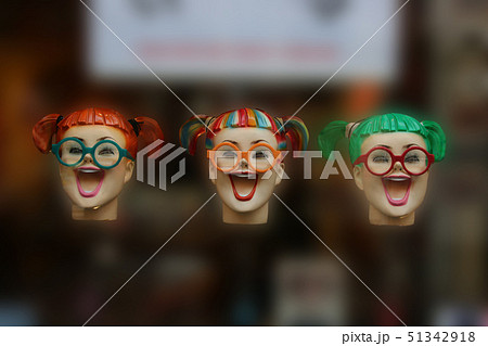 Three colourful fake laughing woman heads floating 51342918