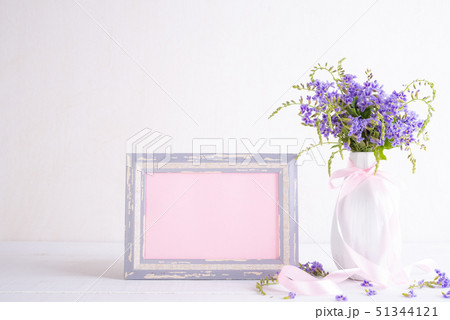 White picture frame with lovely purple flower 51344121
