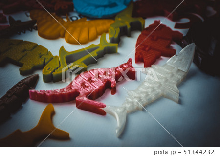Many bright multi-colored objects printed on 3d printer lie on flat surface Many bright multi-colored objects printed on 3d printer lie on flat surface 51344232
