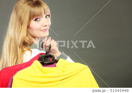 woman customer holding hangers with clothes woman customer holding hangers with clothes 51345440