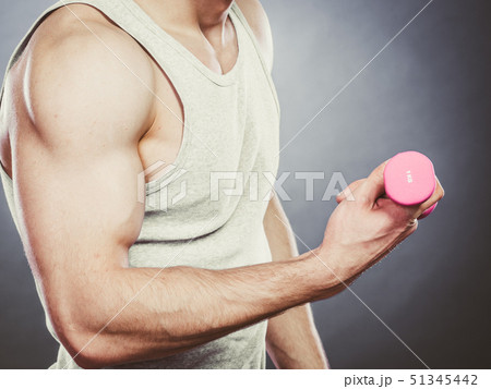 Funny sporty fit man lifting light dumbbell. Fun. Funny sporty fit man lifting light dumbbell. Fun. 51345442