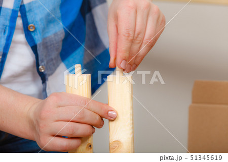 Human assembling wood furniture. DIY. 51345619
