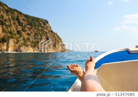 woman lounging on a catamaran sailboat 51347080
