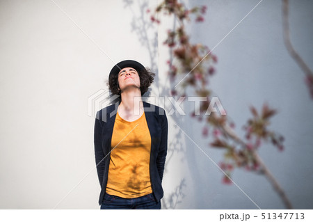 A young businesswoman standing outdoors, relaxing. Copy space. 51347713