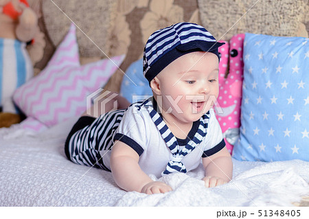 A sweet little child in a striped shirt and hats 51348405
