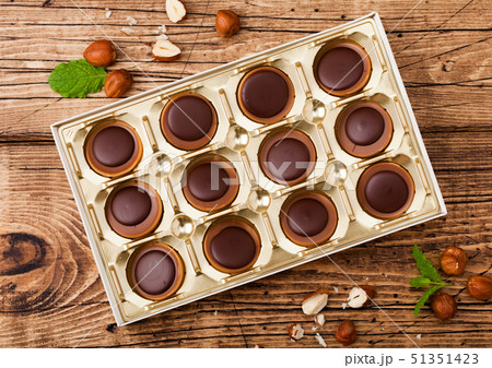 Box of homemade candies on wooden background Box of homemade candies on wooden background 51351423