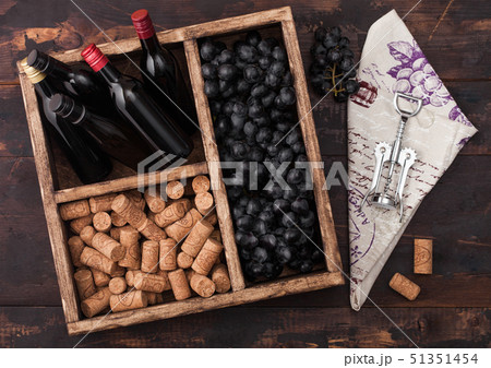 Mini bottles of red wine with dark grapes Mini bottles of red wine with dark grapes 51351454