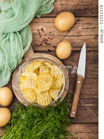 Homemade potato crisp chips inside glass bowl Homemade potato crisp chips inside glass bowl 51351576
