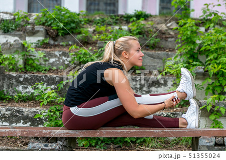 Fitness lifestyle. Young woman warming up 51355024
