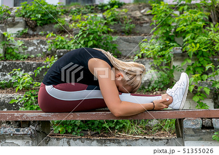 Fitness lifestyle. Young woman warming up 51355026