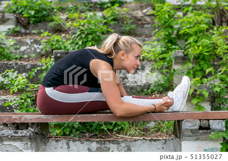 Fitness lifestyle. Young woman warming up 51355027